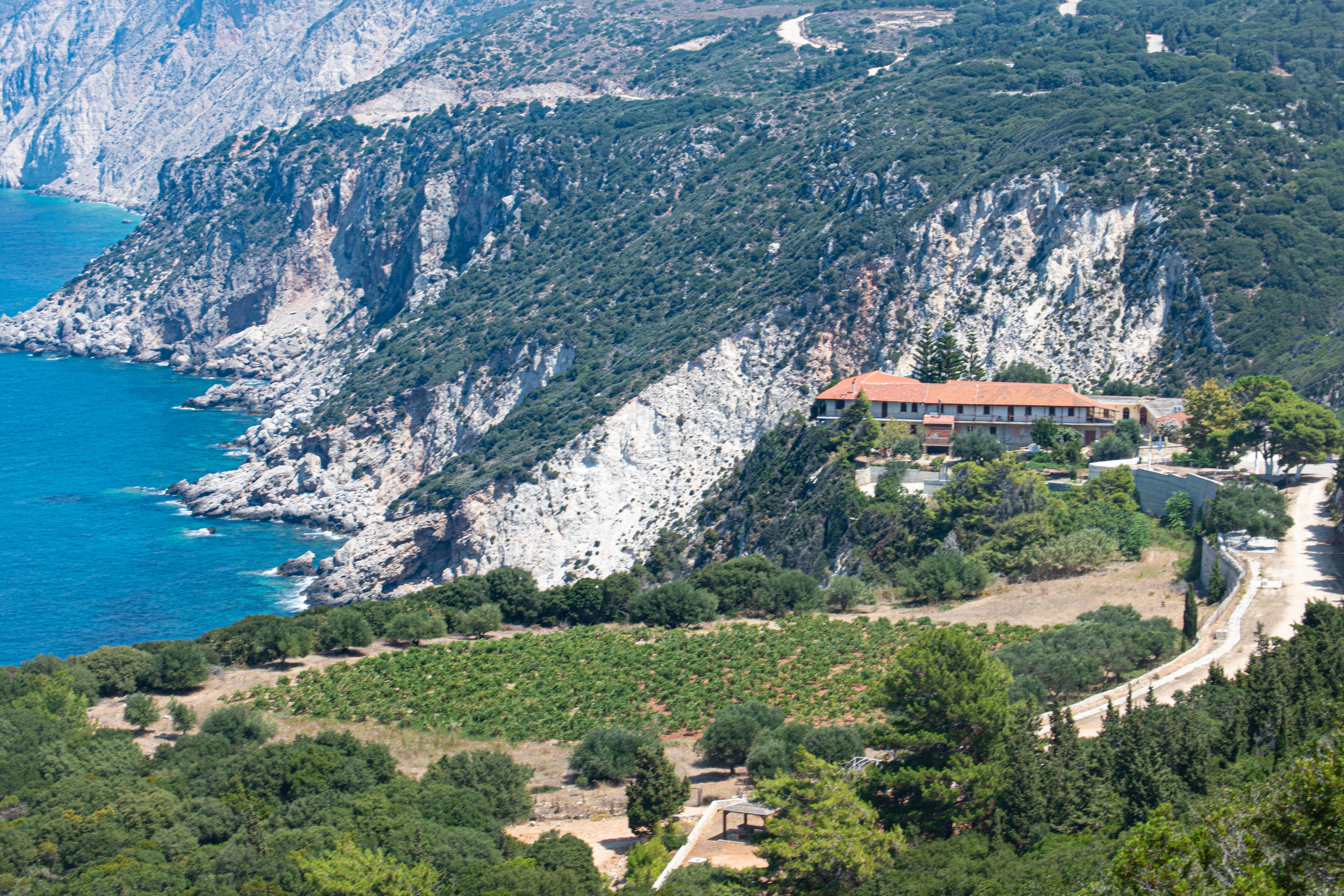 View of the geosite where Rockfalls, landslides and slope failures can be seen that testify to the intense tectonic activity. The Holy Monastery of Kipouria can be also seen.